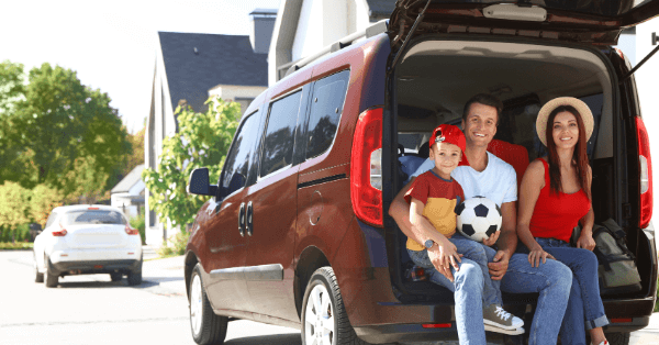 Family sitting in back of minivan