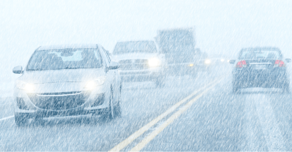 Multiple cars driving on a wintery highway